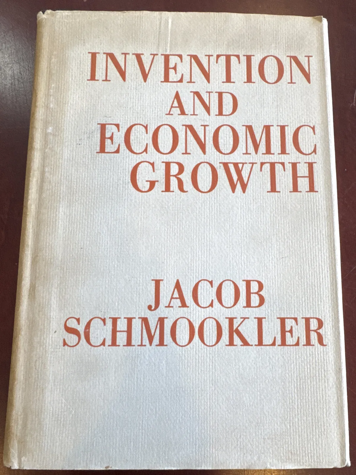 Cream dust jacket of Invention and Economic Growth lettered in red