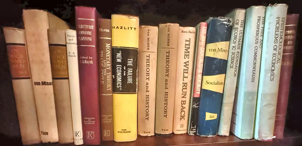 A row of Mises and Hayek books on our shelf